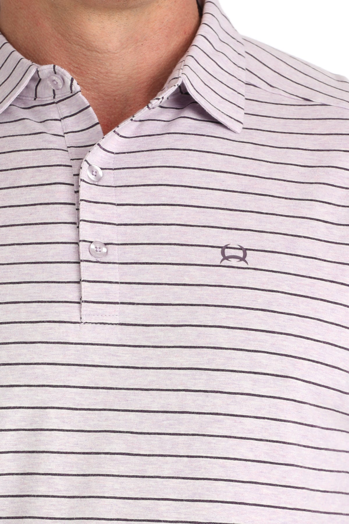 Close-up of a striped polo shirt with a brand logo on a white background