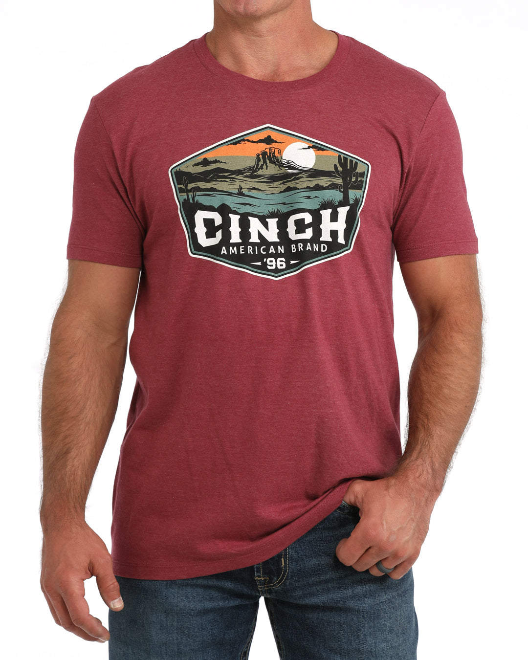 Man wearing a maroon t-shirt with a graphic design and 'Cinch' branding.