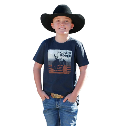 Child wearing a navy blue t-shirt with a graphic design and a black cowboy hat on a white background