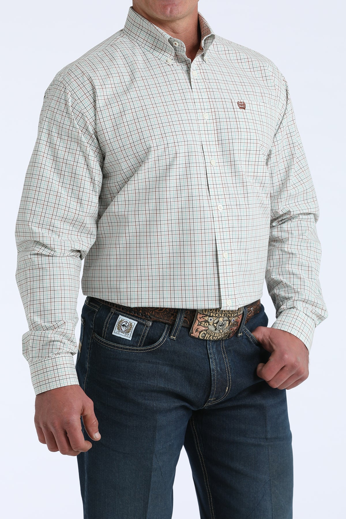 Men's long sleeve plaid button-down shirt with embroidered logo, paired with dark jeans and western belt.
