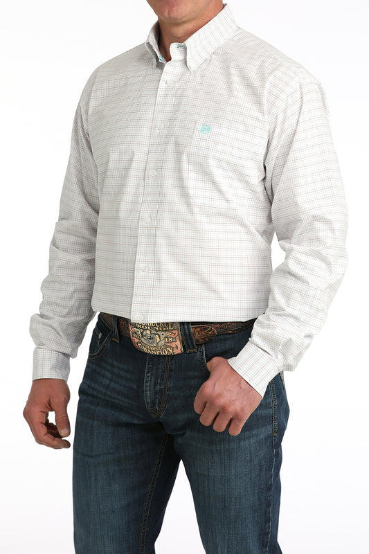 Man wearing a white button-up shirt with a subtle pattern and blue jeans on a white background