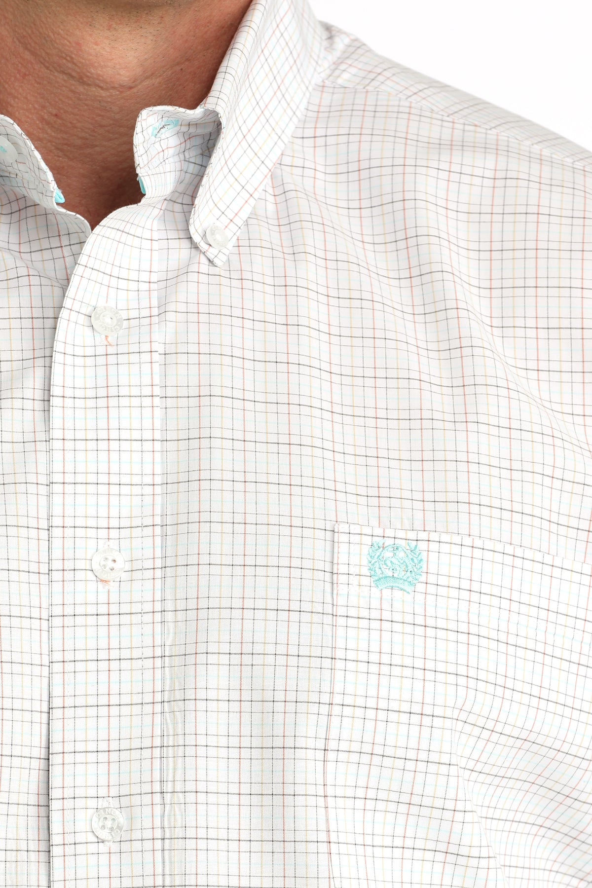 Close-up of a white checkered shirt with a small logo on the chest.