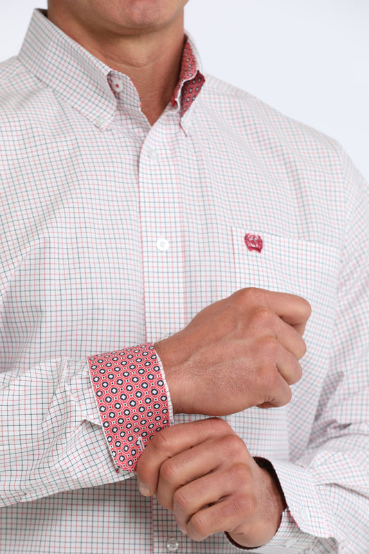 Close-up of a person wearing a checkered shirt with a red and white pattern on the cuffs.