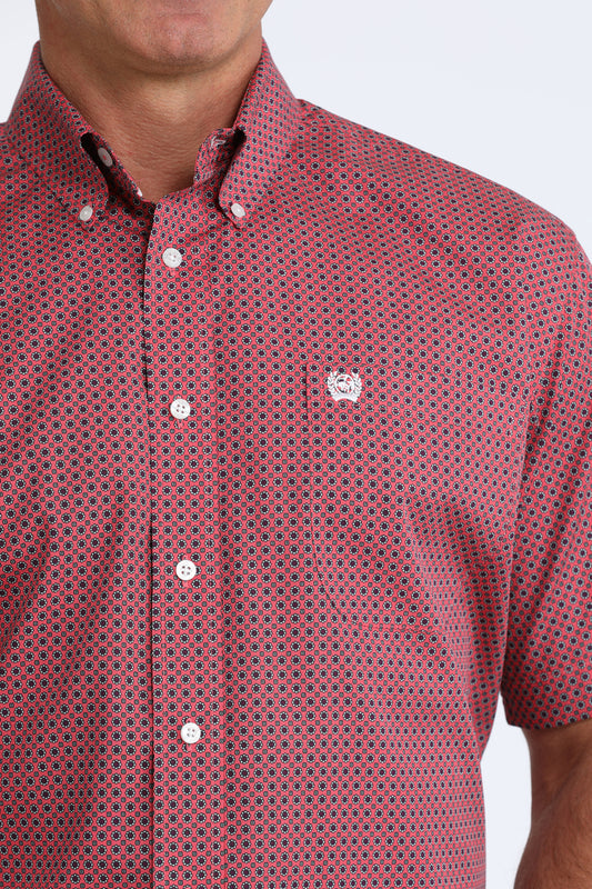 Red patterned shirt worn by a person on a white background