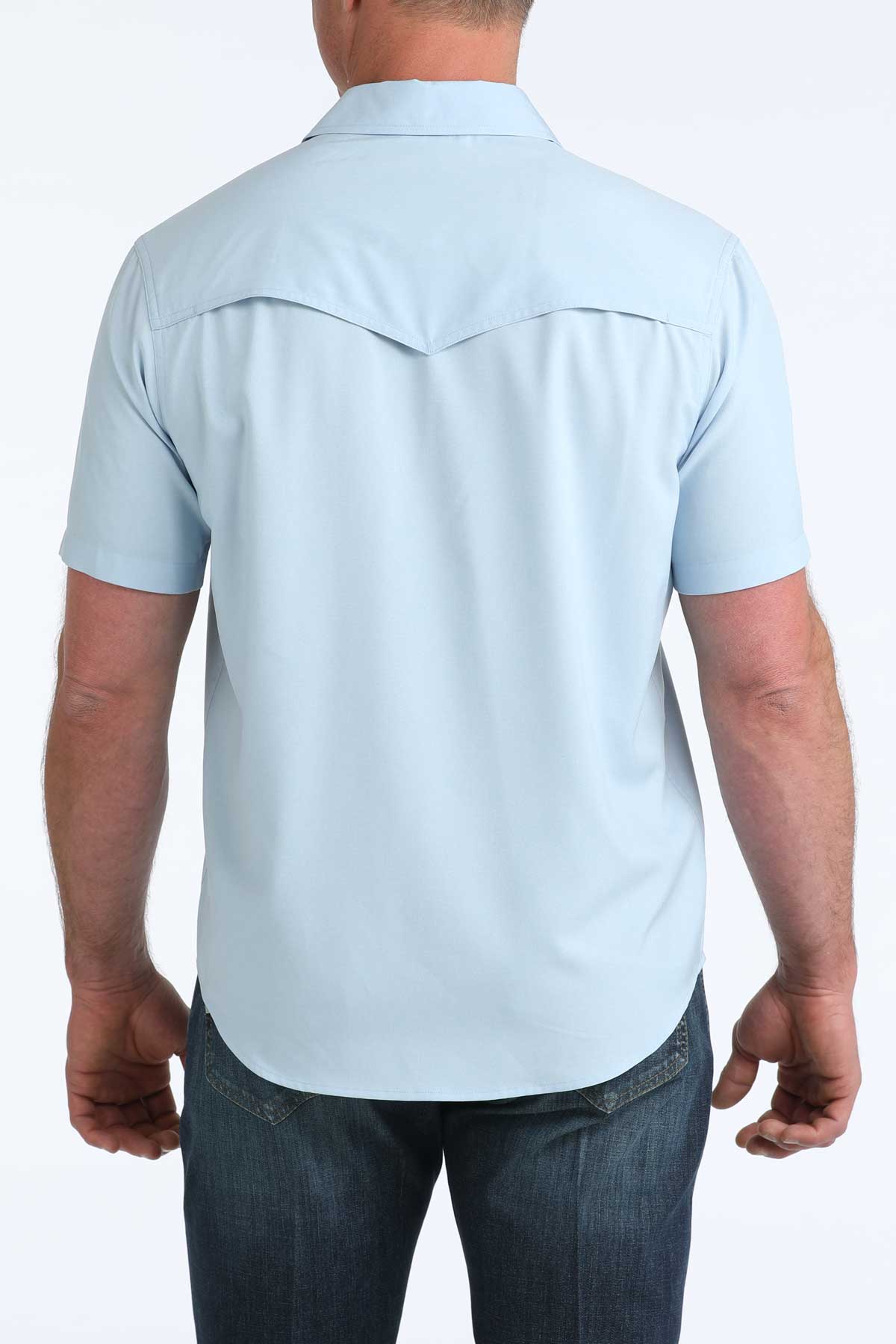 Light blue short-sleeve shirt worn by a person on a white background