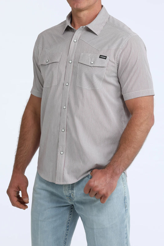 Man wearing a gray short-sleeve button-up shirt with a subtle pattern on a white background