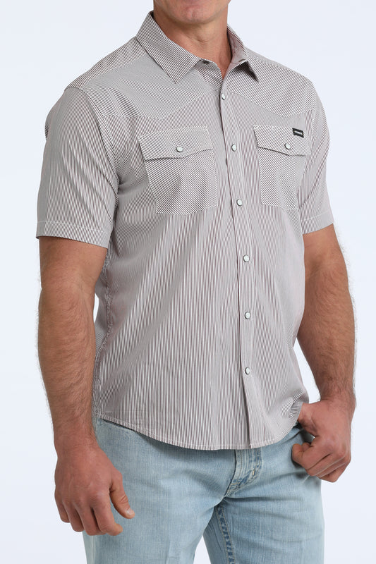 Man wearing a gray short-sleeve button-up shirt with a subtle pattern on a white background