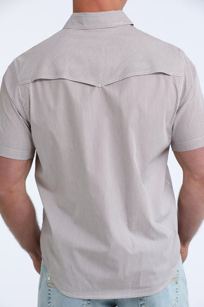 Man wearing a gray short-sleeve button-up shirt with a subtle pattern on a white background