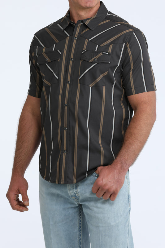 Man wearing a black patterned shirt with short sleeves on a white background