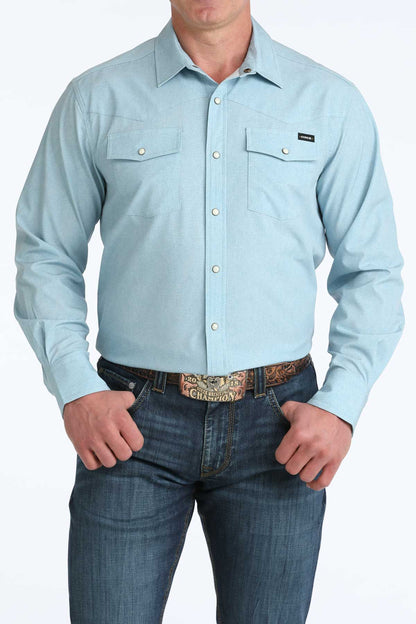 Light blue button-up shirt worn by a person on a white background