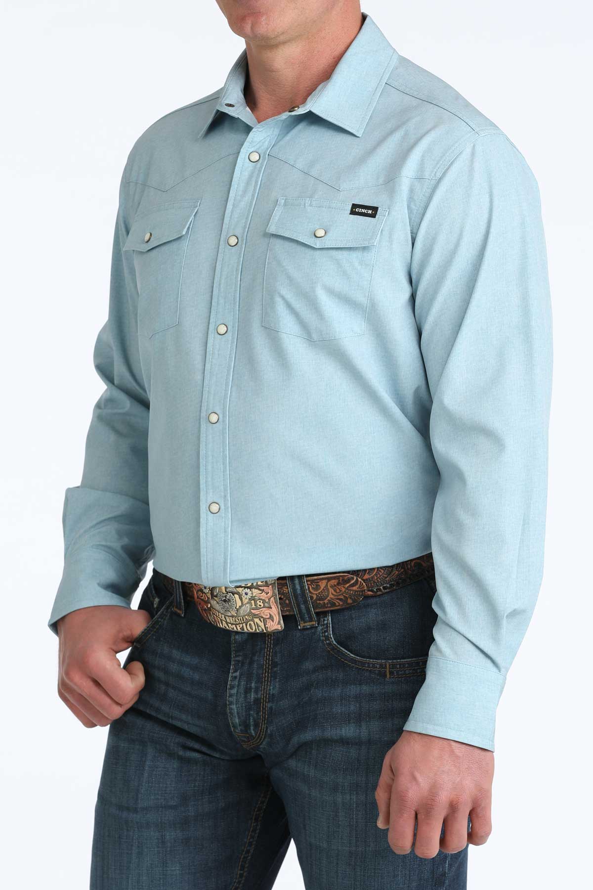 Light blue button-up shirt worn by a person on a white background