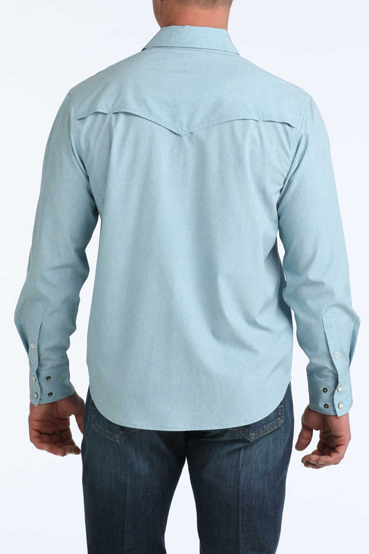 Light blue button-up shirt worn by a person on a white background