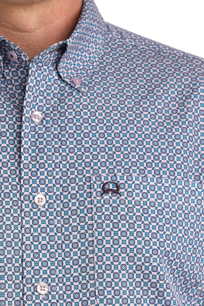 Close-up of a patterned shirt with a brand logo on a white background