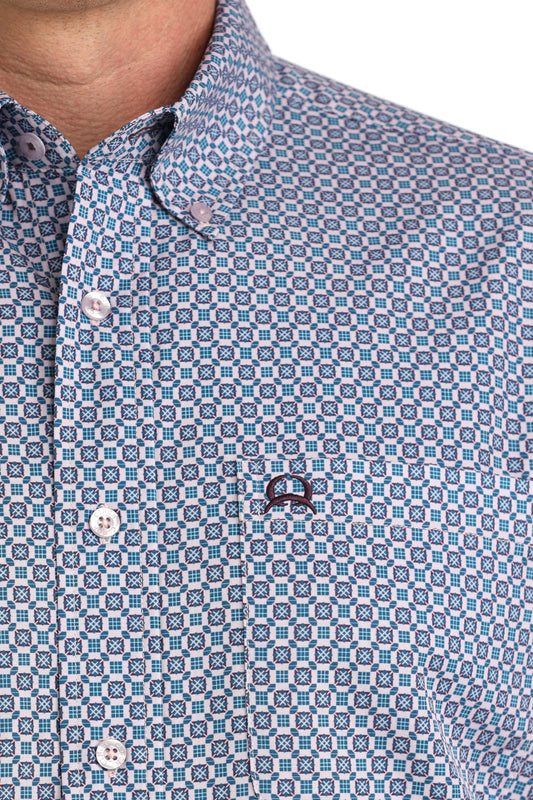 Close-up of a patterned shirt with a brand logo on a white background
