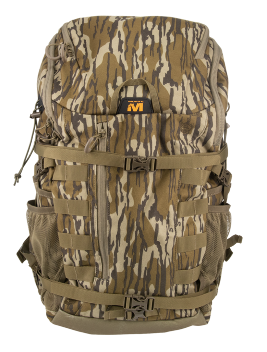 A large tactical backpack in a woodland camouflage pattern with brown, tan, and gray tones, featuring multiple compression straps, side mesh pockets, and a black and orange logo patch on the front.