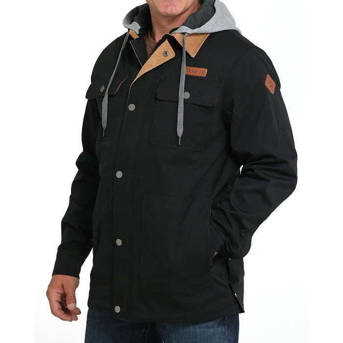Men's black utility jacket with front pockets, snap buttons, and gray hood