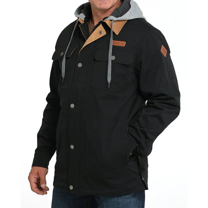 Men's black utility jacket with front pockets, snap buttons, and gray hood