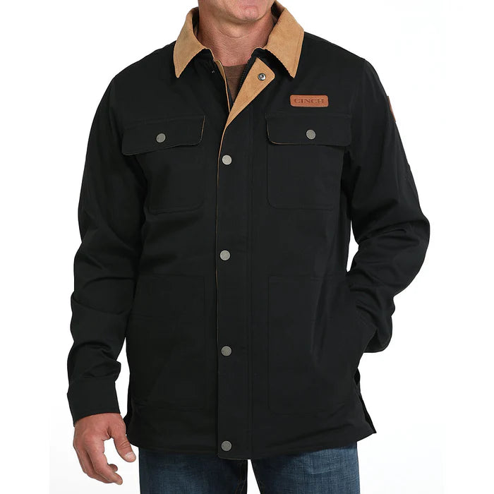 Men’s black work jacket with tan collar, snap buttons, and chest pockets