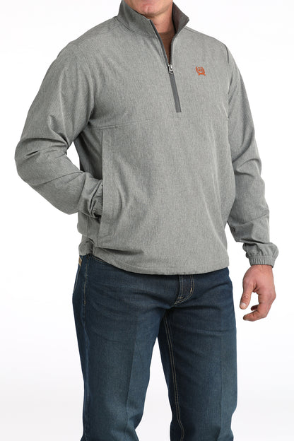Man wearing a gray quarter-zip pullover jacket with jeans, front view on white background
