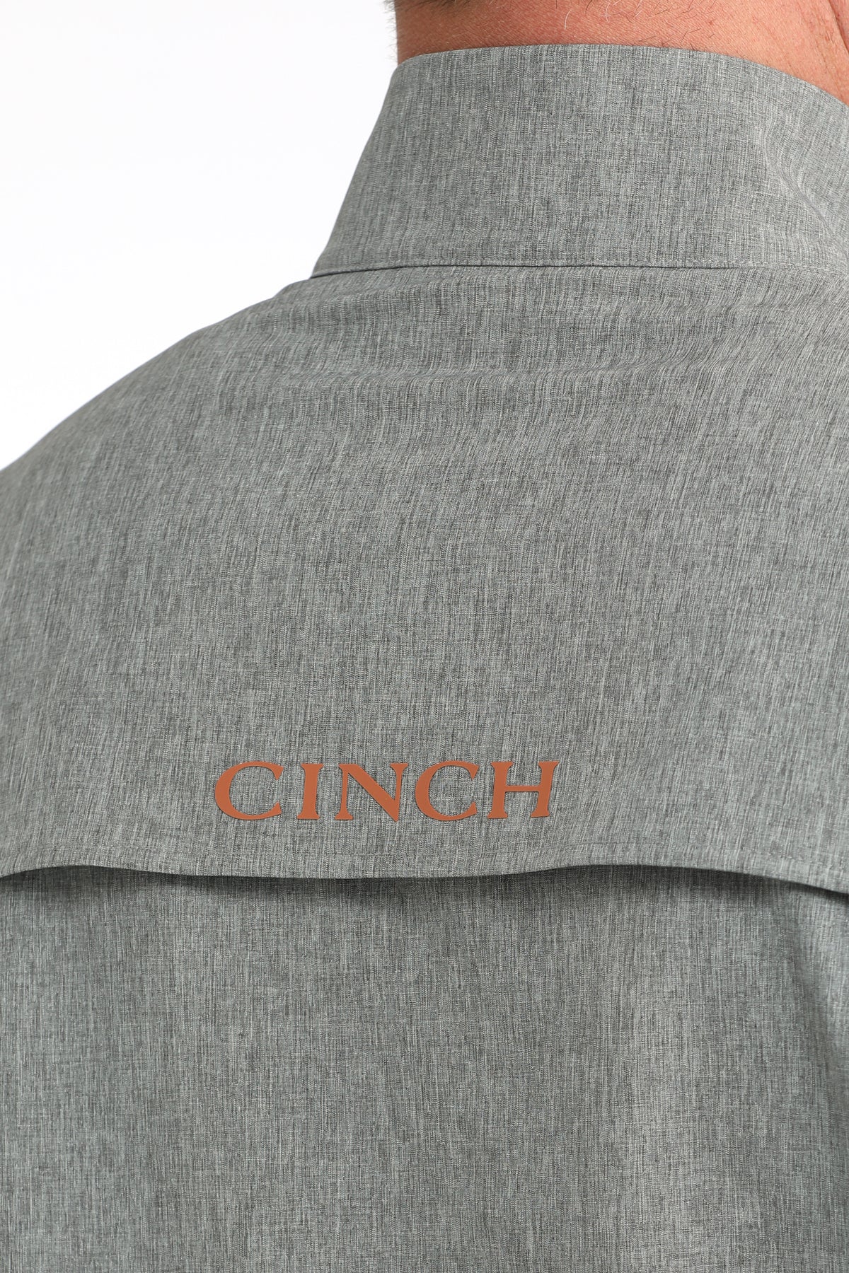 Close-up of men's gray button-up shirt back with CINCH logo on yoke