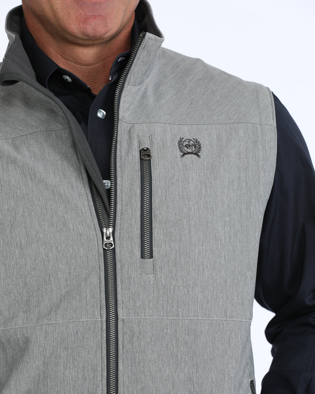 Gray zip-up jacket with a brand logo on a white background