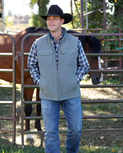 olive vest with horse in background
