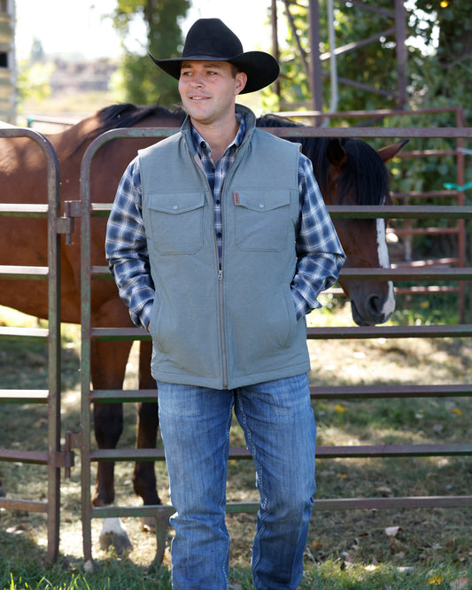 olive vest with horse in background