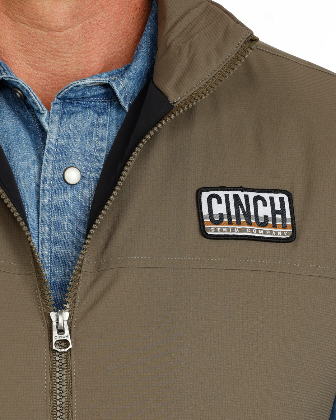 green vest with CINCH logo