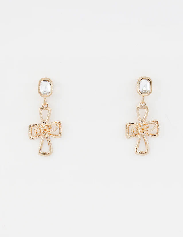 Gold cross-shaped earrings with clear stones on a white background