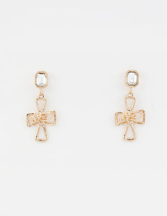 Gold cross-shaped earrings with clear stones on a white background