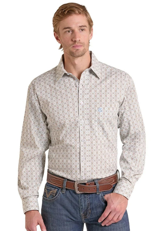 A man wearing a long-sleeve western-style button-down shirt with a small geometric pattern in beige and brown, paired with blue jeans and a brown leather belt, against a plain white background.
