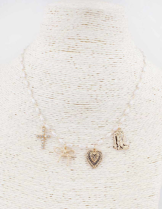 Set of gold necklaces with various pendants on a textured white background