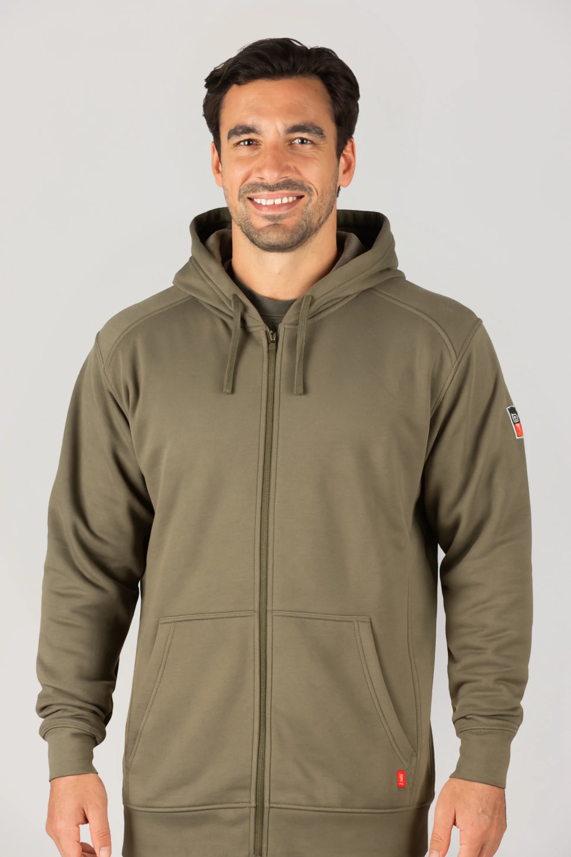 Man wearing a green hoodie with a brand logo on a gray background