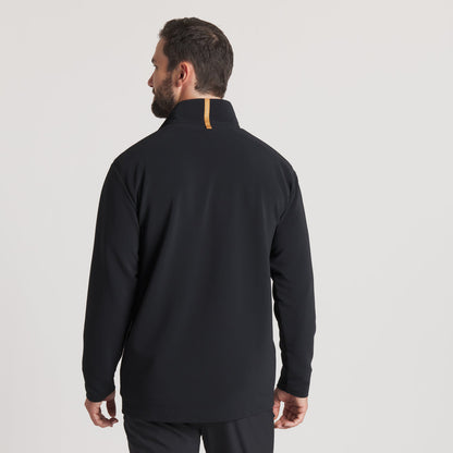 Man wearing black long sleeve jacket with high collar and tan accent, back view.