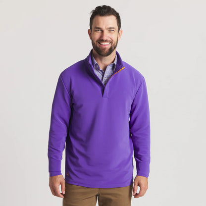Man wearing a purple quarter-zip pullover with collared shirt and khaki pants