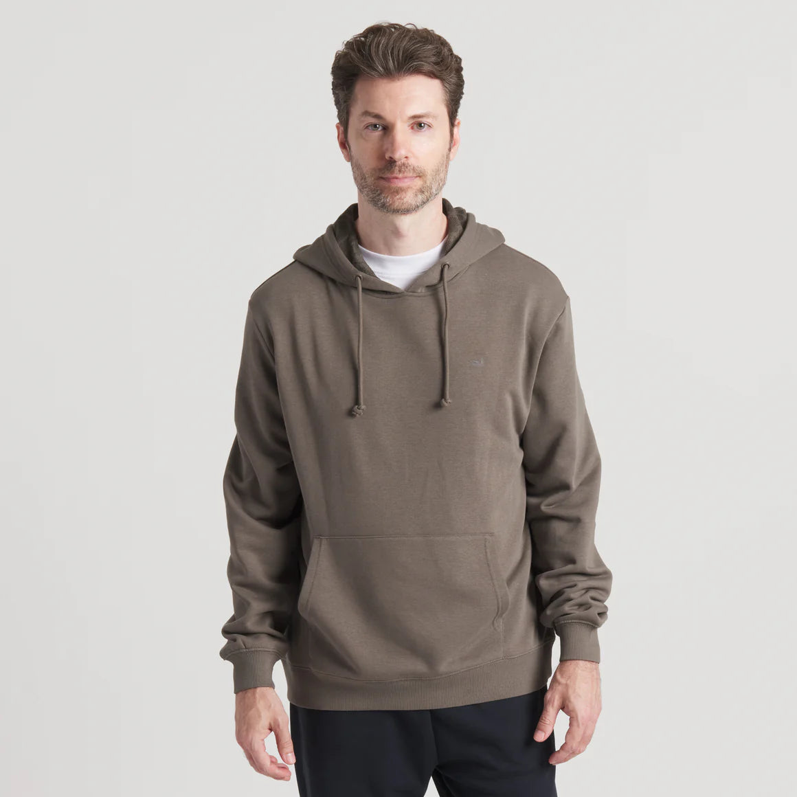 Man wearing olive green pullover hoodie with front pocket and drawstring, casual style
