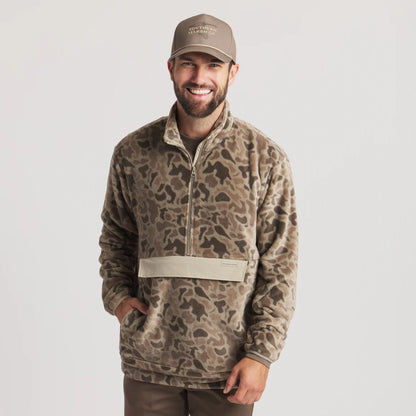 Man wearing camouflage print fleece pullover and khaki cap with front pocket, outdoor apparel