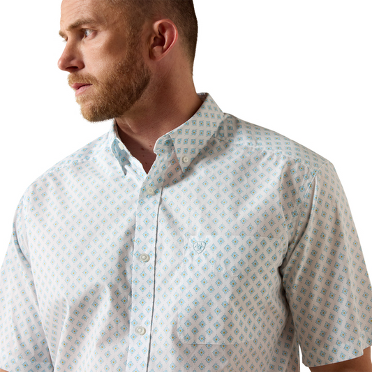 Man wearing a patterned shirt on a white background