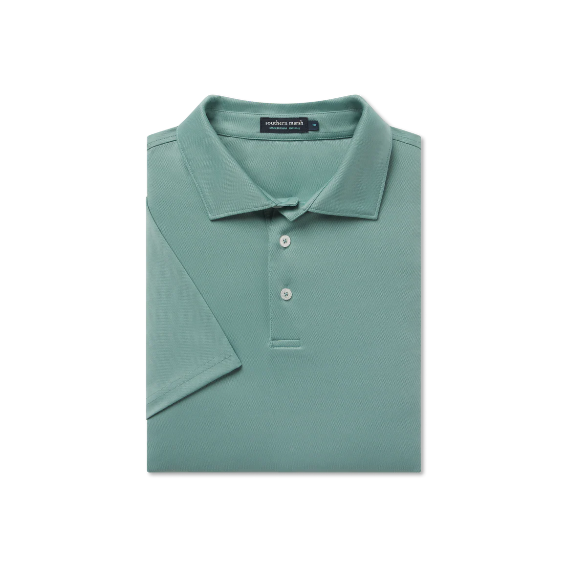 Folded green polo shirt with a brand label on a white background