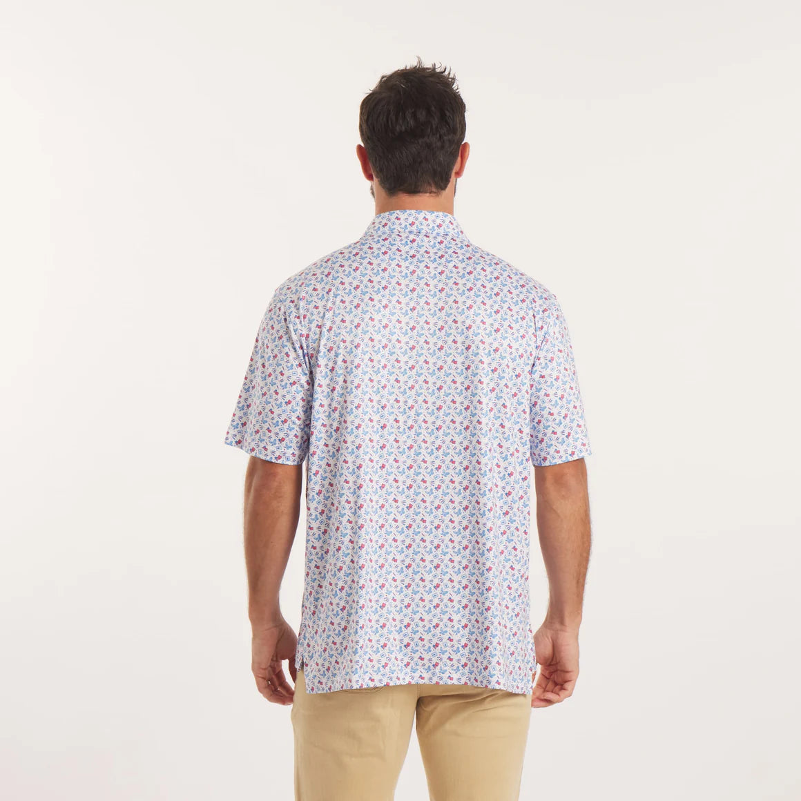 Man wearing a patterned short-sleeve shirt on a white background