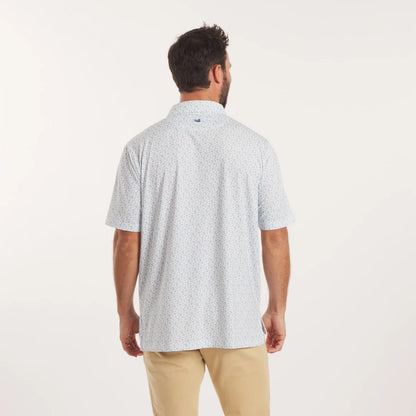Man wearing a light blue patterned shirt and beige pants on a white background