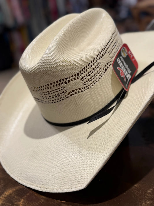 White cowboy hat with a brand tag on a wooden surface