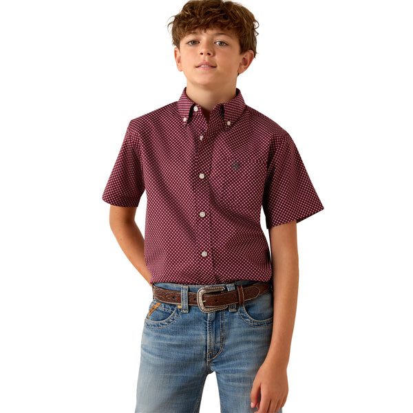Child wearing a red checkered shirt and blue jeans on a white background