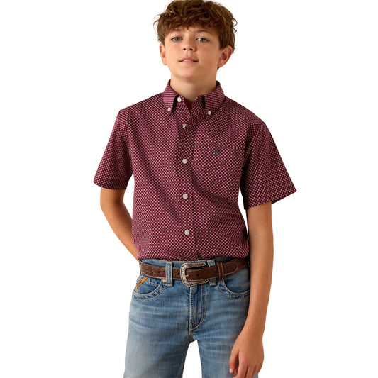 Child wearing a red checkered shirt and blue jeans on a white background
