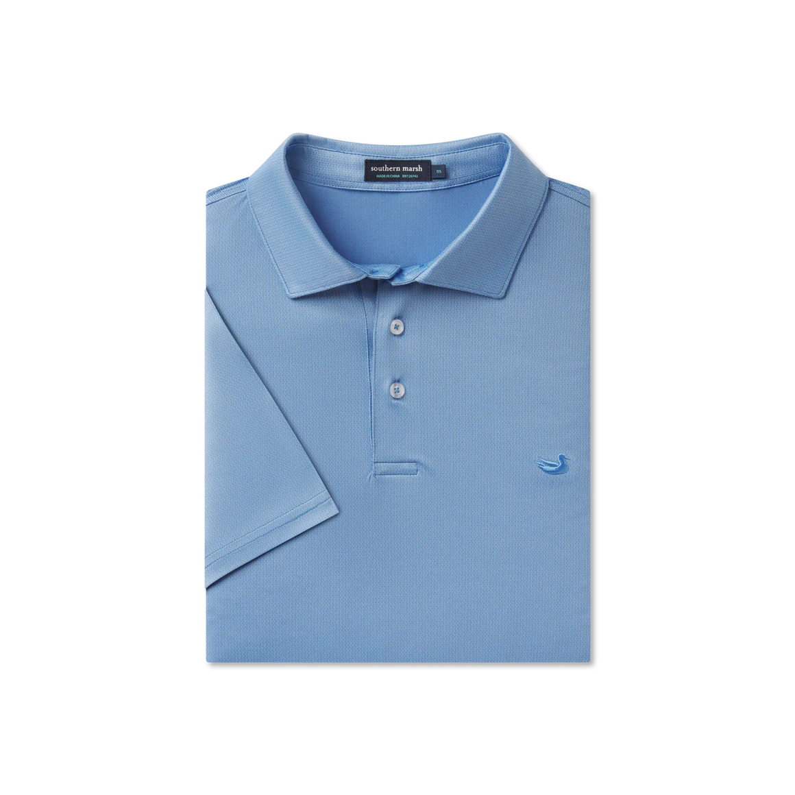 Folded blue polo shirt with a brand label on a white background
