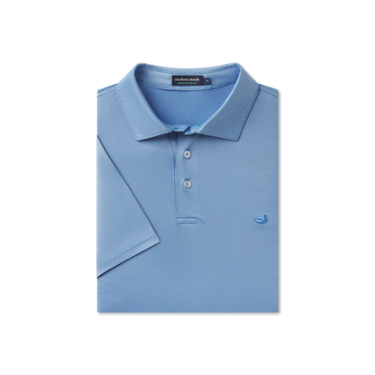 Folded blue polo shirt with a brand label on a white background