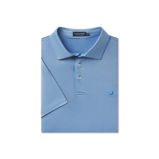 Folded blue polo shirt with a brand label on a white background
