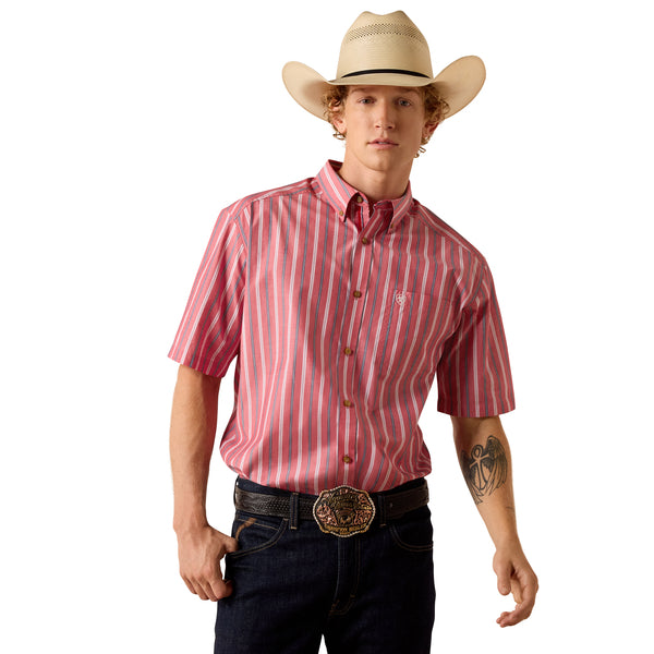 Man wearing a red striped shirt, dark jeans, and a cowboy hat on a white background