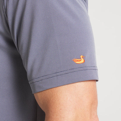 Close-up of gray short sleeve shirt with orange duck embroidery on sleeve.