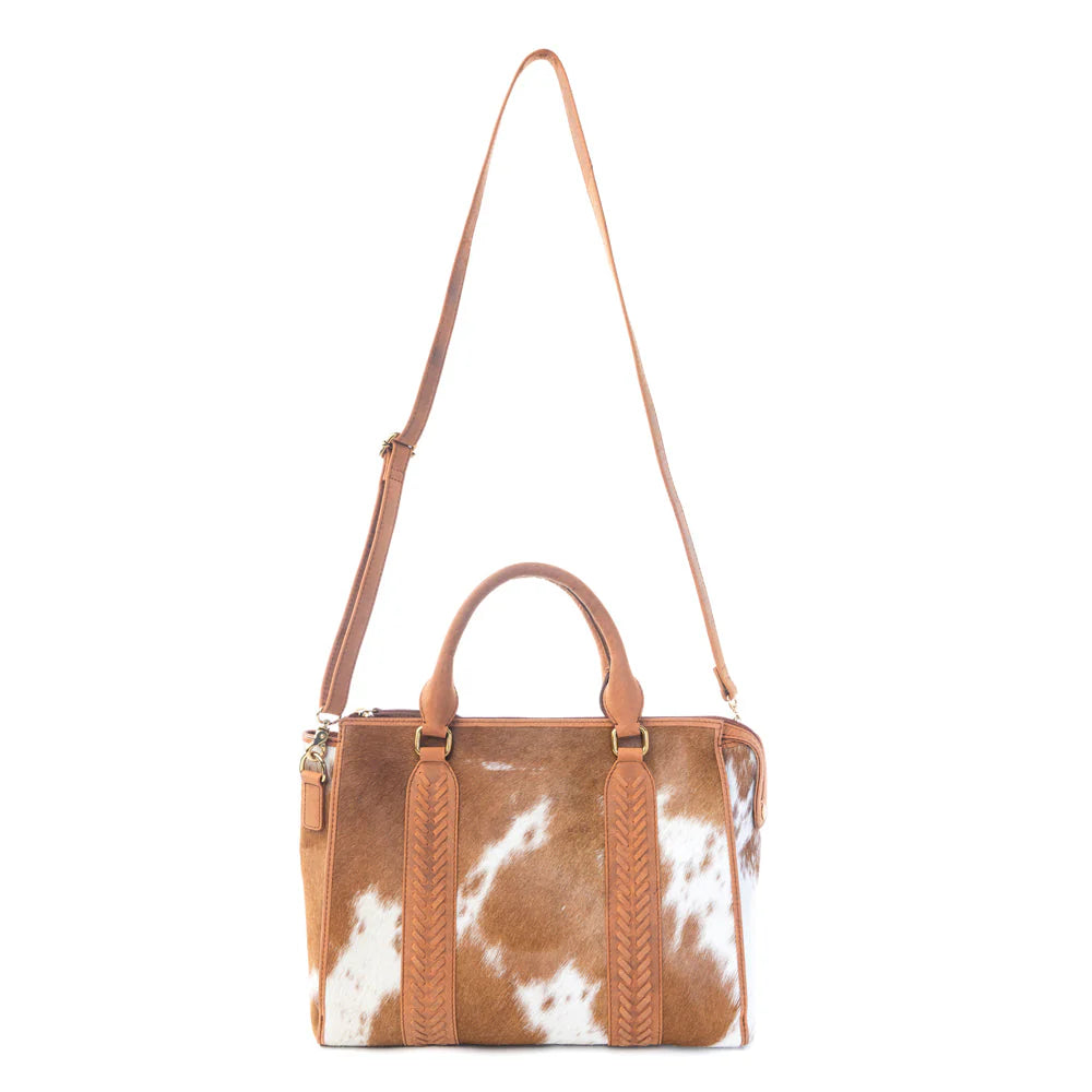 Brown and white cowhide leather satchel bag with shoulder strap and top handles